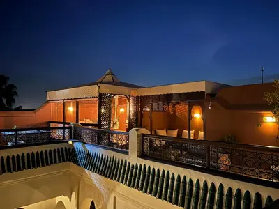 a house with a balcony at night at Riad Dar Zaouia in Marrakech