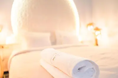 a roll of toilet paper sitting on a bed at Riad L'ECOLE in Marrakech