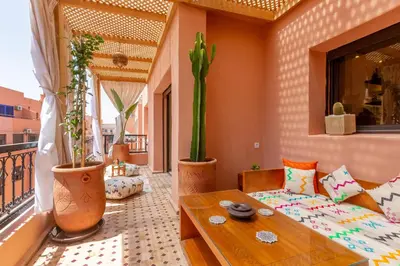 a living room with a couch and a table at Le Palmier - Appartement Authentique à Gueliz in Marrakech