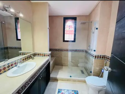 a bathroom with a toilet and a sink and a shower at The Villa avec piscine chauffée 4 chambres in Marrakech