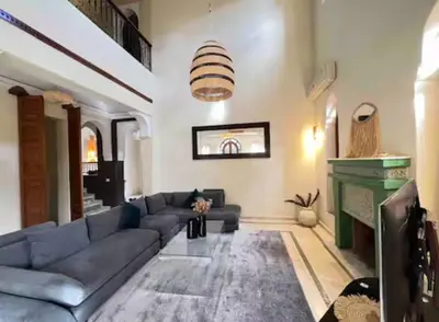 a living room with a couch and a fireplace at The Majestic Marrakesh Villa 16 in Marrakech