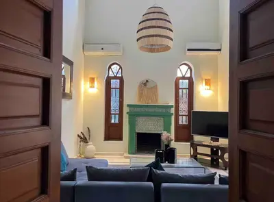 a living room with a blue couch and a fireplace at The Majestic Marrakesh Villa 16 in Marrakech