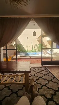 a person laying on a bench in a room with a window at Riad Laila Marrakech in Marrakech