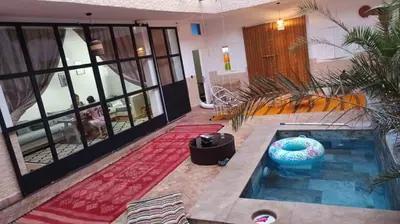 a room with a swimming pool in a house at Riad Laila Marrakech in Marrakech
