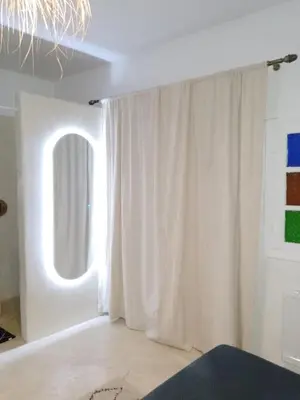 a room with a white curtain and a window at Riad Laila Marrakech in Marrakech
