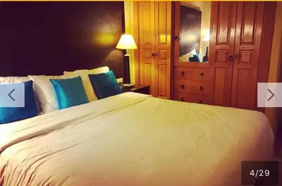 a bedroom with a large white bed with blue pillows at palmeraie village 2 in Marrakech