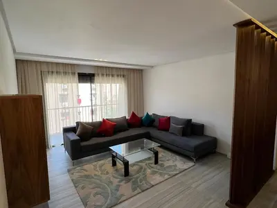 a living room with a couch and a coffee table at Appartement deux chambres salon Centre de Gueliz 23 in Marrakech