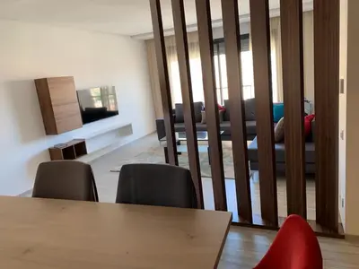 a dining room with a table and chairs and a couch at Appartement deux chambres salon Centre de Gueliz 23 in Marrakech