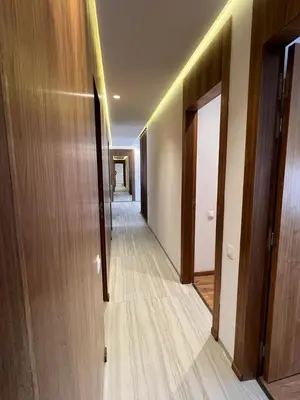 a hallway with wooden floors and a hallway with doors at Appartement deux chambres salon Centre de Gueliz 23 in Marrakech