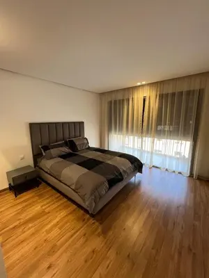 a bedroom with a large bed and a wooden floor at Appartement deux chambres salon Centre de Gueliz 23 in Marrakech