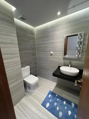 a bathroom with a toilet and a sink and a mirror at Appartement deux chambres salon Centre de Gueliz 23 in Marrakech