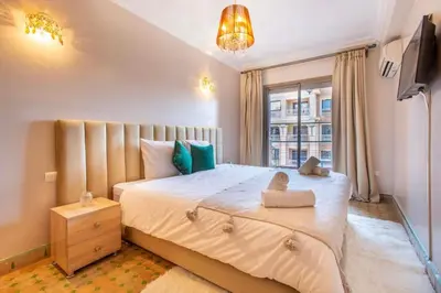 a bedroom with a large bed and a window at Luxury Appartement gueliz center in Marrakech