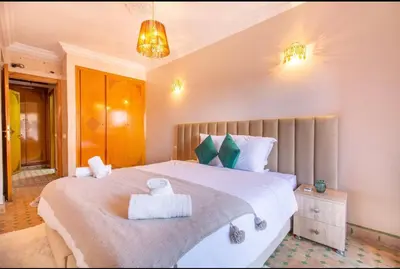 a bedroom with a large bed with towels on it at Luxury Appartement gueliz center in Marrakech
