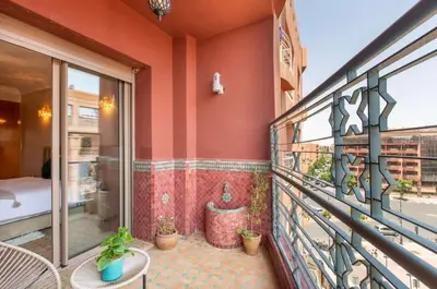 a balcony with a table and some plants on it at Luxury Appartement gueliz center in Marrakech