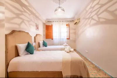 a bedroom with two beds and a window at Luxury Appartement gueliz center in Marrakech