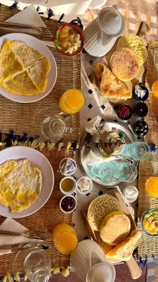 a table filled with plates and bowls of food at Riad Hayat in Marrakech