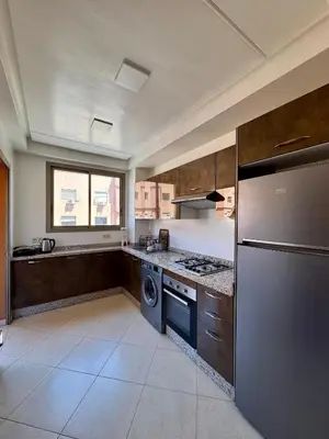 a kitchen with a stainless steel refrigerator and a dishwasher at Charmant Appartement au Cœur de la Ville in Marrakech