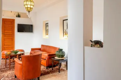 a living room with a couch and a table at Riad Thé d'Orient - Piscine Privée - Petit Déjeuner in Marrakech