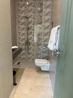 a bathroom with a toilet and a glass shower at Villa avec pool privé avenue Mohamed 6 zone touristique Agdal in Marrakech
