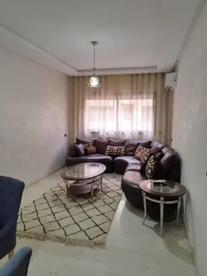 a living room with a couch and two tables at Luxury Apartment Marrakesh in Marrakech