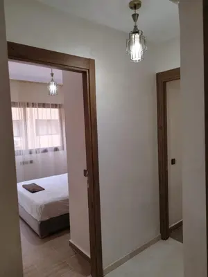 a bedroom with a bed and a mirror at Luxury Apartment Marrakesh in Marrakech