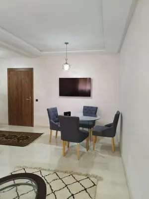 a dining room with a table and chairs at Luxury Apartment Marrakesh in Marrakech