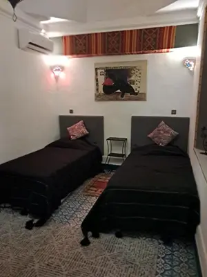a room with two beds in a room at Riad El Badii chambre twin Bahia in Marrakech