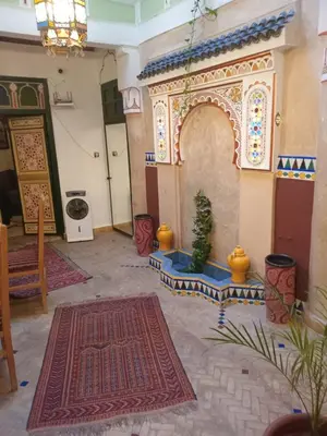 a living room with a rug and a christmas tree at Riad El Badii chambre twin Bahia in Marrakech