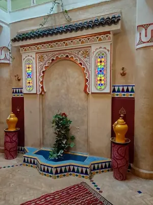 a room with a potted plant and stained glass windows at Riad El Badii chambre twin Bahia in Marrakech