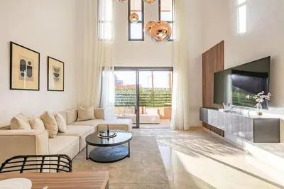 a living room with a couch and a tv at Duplex Design, Terrasse résidence Menara garden in Marrakech