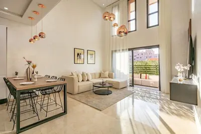 a living room with a couch and a table at Duplex Design, Terrasse résidence Menara garden in Marrakech
