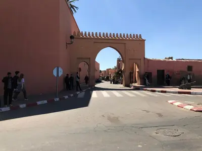 a building with an arch in the middle of a street at Dar Oki in Marrakech