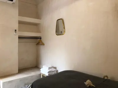 a bedroom with a bed and a mirror on the wall at Dar Oki in Marrakech