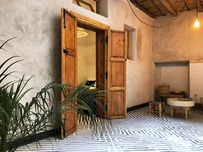 an open door to a room with a plant at Dar Oki in Marrakech