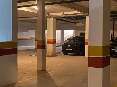a parking garage with a car parked in it at Appartement de Haut Standing. in Marrakech