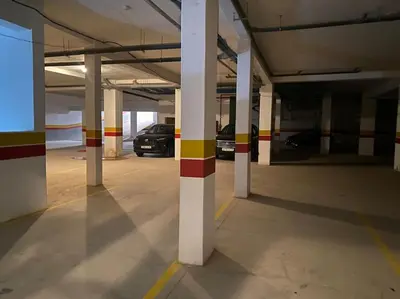 an empty parking garage with two cars parked in it at Appartement de Haut Standing. in Marrakech