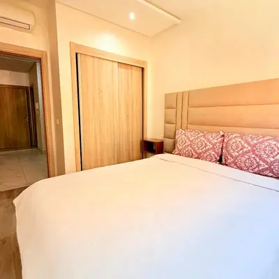 a bedroom with a large white bed with two pillows at Studio N9 COSY Avec Balcon in Marrakech