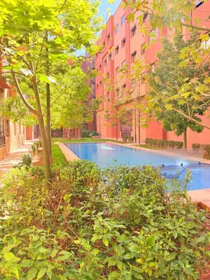 a swimming pool in front of a building at Studio N9 COSY Avec Balcon in Marrakech