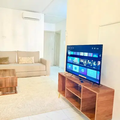 a living room with a large flat screen tv at Studio N9 COSY Avec Balcon in Marrakech