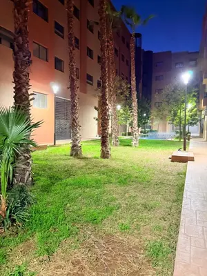 a park in front of a building at night at Studio N9 COSY Avec Balcon in Marrakech
