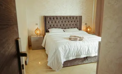 a bedroom with a large bed with a white comforter at Apartment in Marrakech in Marrakech