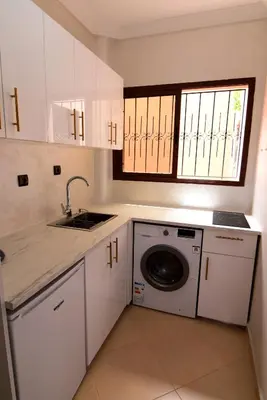 a kitchen with a sink and a washing machine at KECHDAYS, Lovely apartment near airport in Marrakech