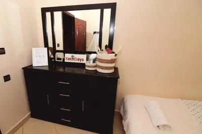 a bathroom with a black dresser and a mirror at KECHDAYS, Lovely apartment near airport in Marrakech