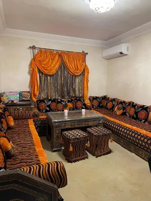 a living room with a couch and a table at KECHDAYS, Lovely apartment near airport in Marrakech