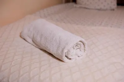 a towel sitting on top of a bed at KECHDAYS, Lovely apartment near airport in Marrakech