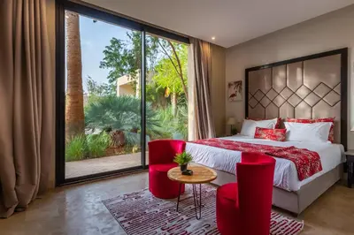 a bedroom with a bed and a large window at Villa Tomazo Marrakech in Marrakech