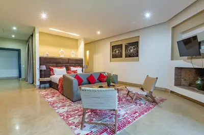 a living room with a couch and a bed at Villa Tomazo Marrakech in Marrakech