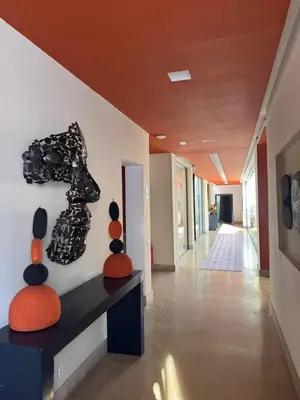 a hallway with art on the wall in a building at Villa Tomazo Marrakech in Marrakech