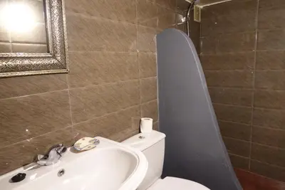 a bathroom with a toilet and a sink and a mirror at Dar Suncial in Marrakech