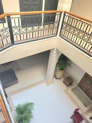 an overhead view of a balcony with two plants at Riad Isahiac avec piscine en exclusivité in Marrakech